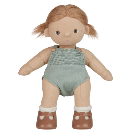A plush doll with light brown hair wears a knitted light teal romper and brown shoes with white socks. The expression is neutral, set against a white background.