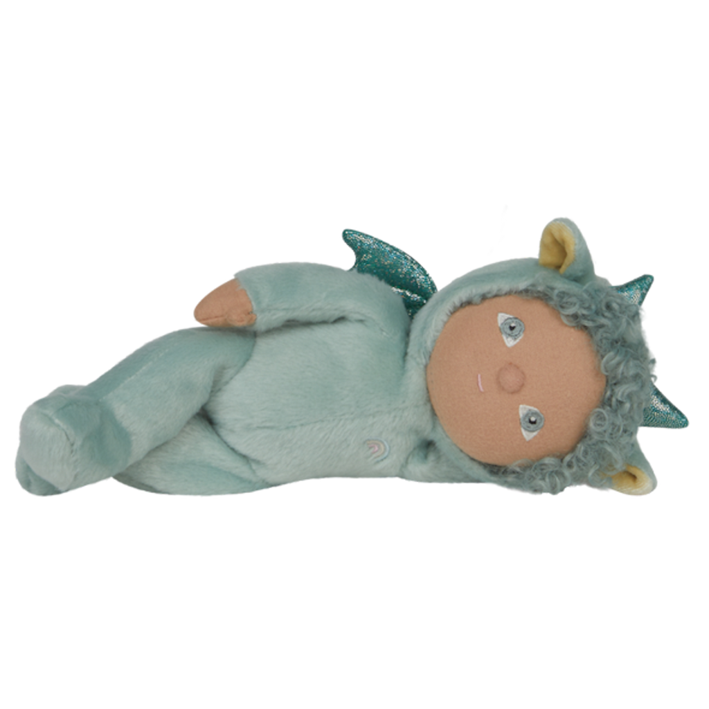 Cute turquoise plush doll with curly hair in a dragon costume featuring sparkling scales and wings, sitting against a white background. Calm and whimsical.