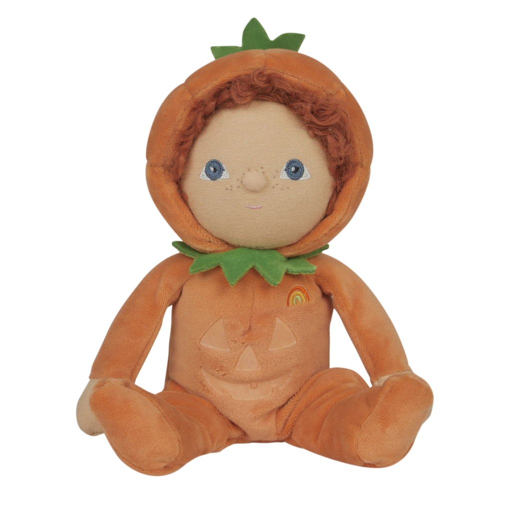Soft doll with curly hair in a pumpkin costume, featuring a green leaf collar and smiling face. The costume has a jack-o'-lantern design and a small rainbow.