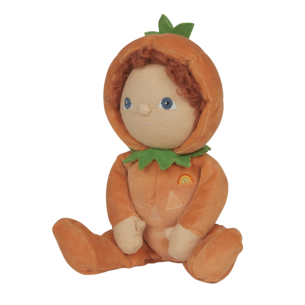 Soft doll with curly hair in a pumpkin costume, featuring a green leaf collar and smiling face. The costume has a jack-o'-lantern design and a small rainbow.