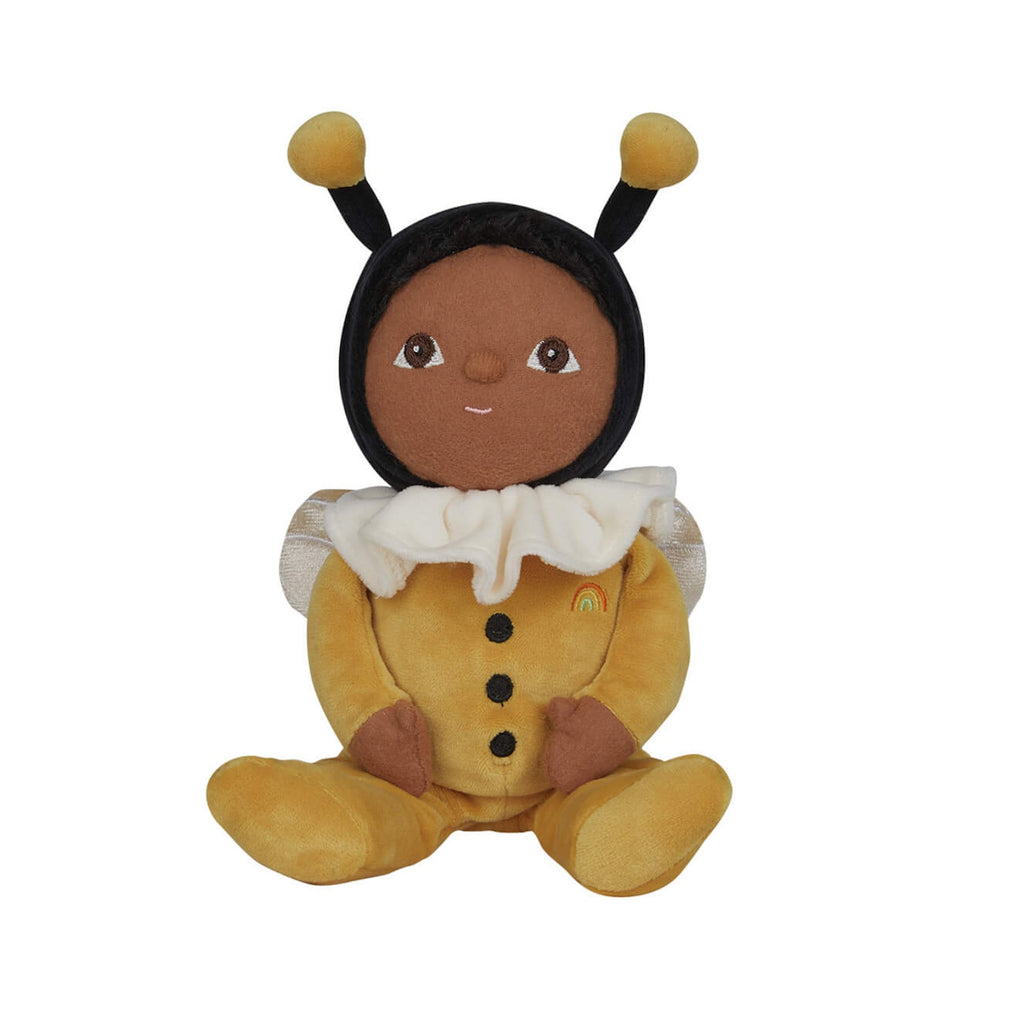 Plush doll dressed as a bee, featuring a black head with bee antennae, a white ruffled collar, and yellow outfit with wing details, sitting upright.