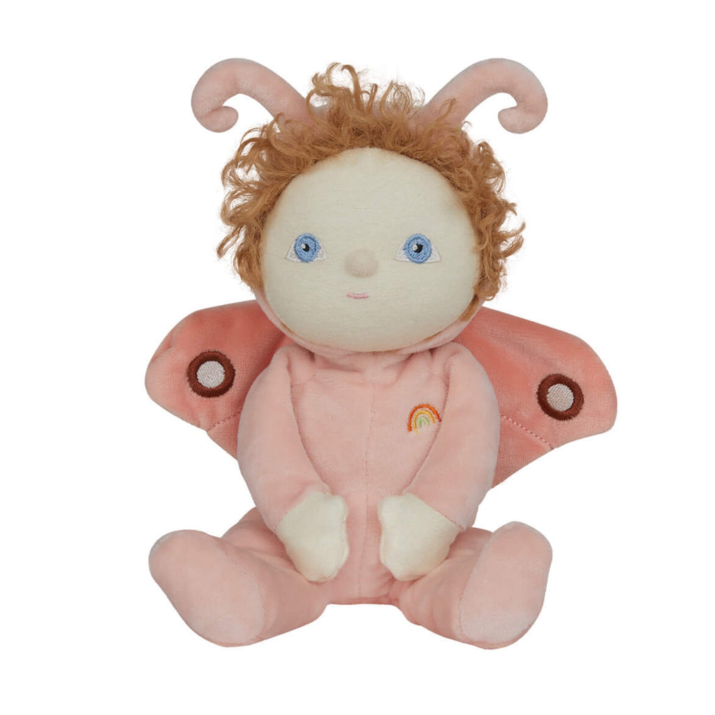 Soft plush doll with curly hair and blue eyes, dressed in a pink butterfly costume with wings and antennae. A small rainbow is embroidered on the outfit.