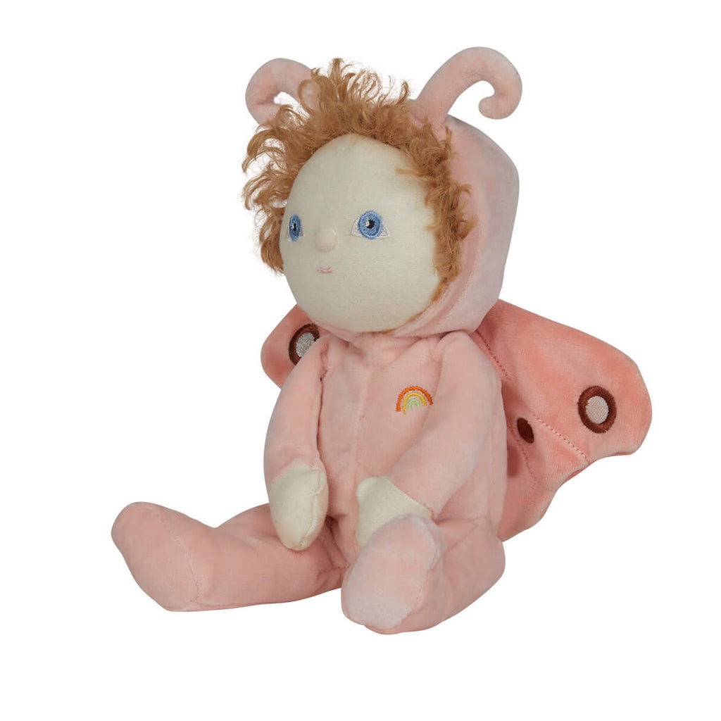 Soft plush doll with curly hair and blue eyes, dressed in a pink butterfly costume with wings and antennae. A small rainbow is embroidered on the outfit.