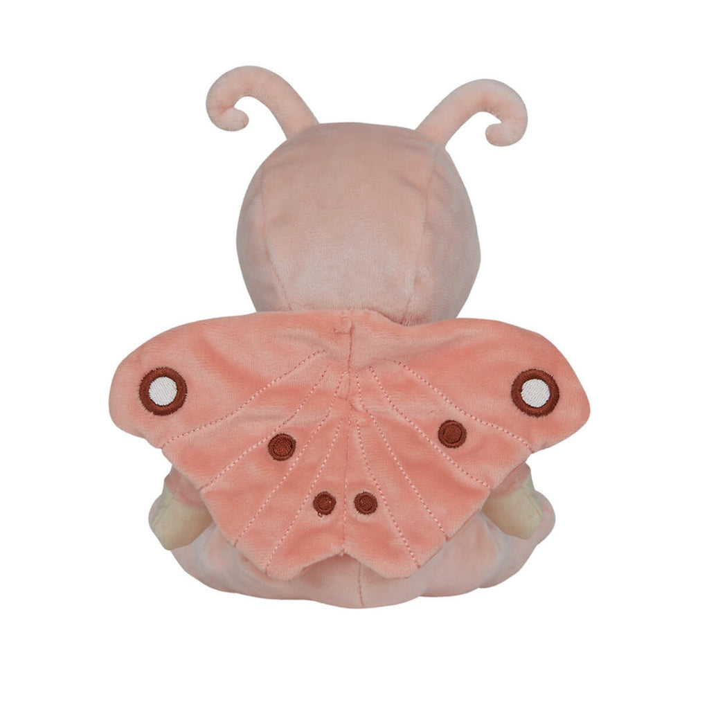 Soft plush doll with curly hair and blue eyes, dressed in a pink butterfly costume with wings and antennae. A small rainbow is embroidered on the outfit.