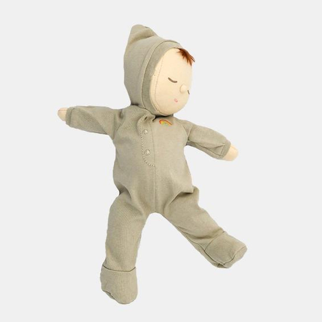 A soft, plush doll in a gray onesie with a small rainbow emblem. The doll has closed eyes and a serene expression, set against a white background.