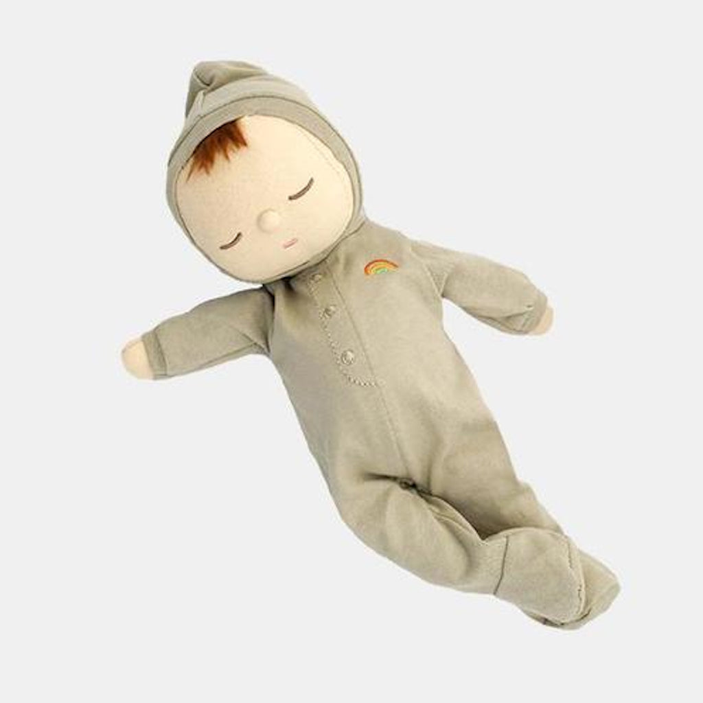 A soft, plush doll in a gray onesie with a small rainbow emblem. The doll has closed eyes and a serene expression, set against a white background.