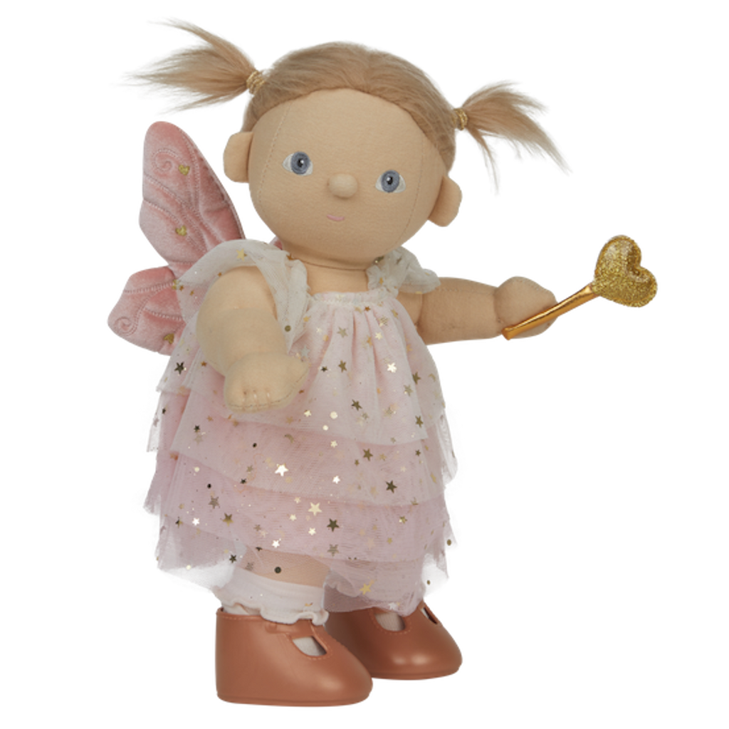 A doll with pigtails wears a pink star-patterned fairy dress, wings, and holds a gold heart wand. The doll has a cheerful expression.
