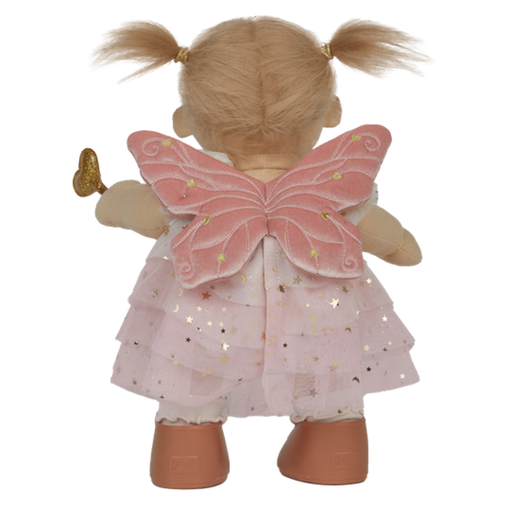A doll with pigtails wears a pink star-patterned fairy dress, wings, and holds a gold heart wand. The doll has a cheerful expression.