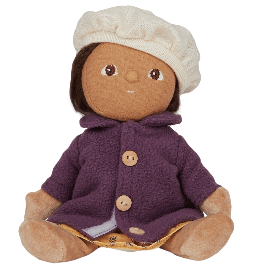 Plush doll with a soft brown face, wearing a cream beret, purple buttoned coat, and yellow dress with patterns, against a white background.