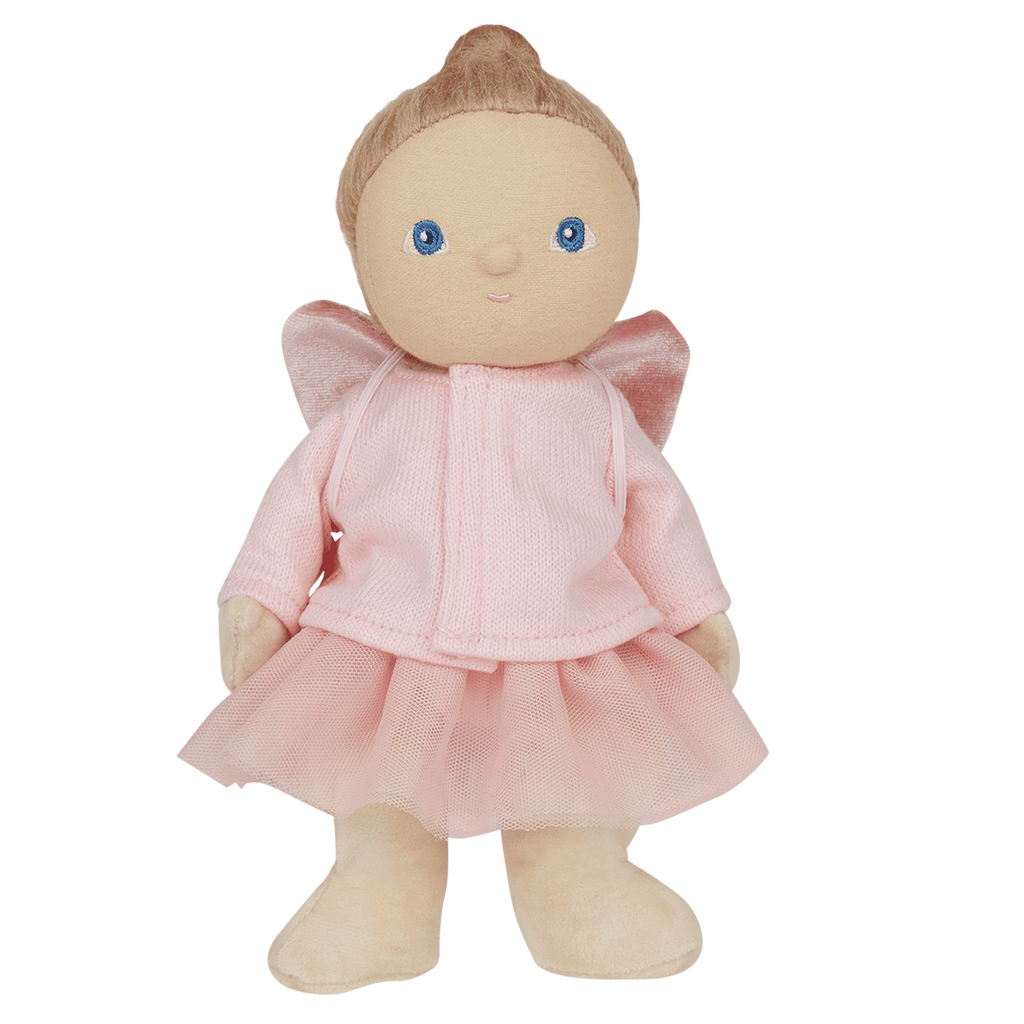 Plush doll with blue eyes and light brown hair, wearing a pink dress with velvet wings. The doll stands against a white background, conveying a whimsical tone.