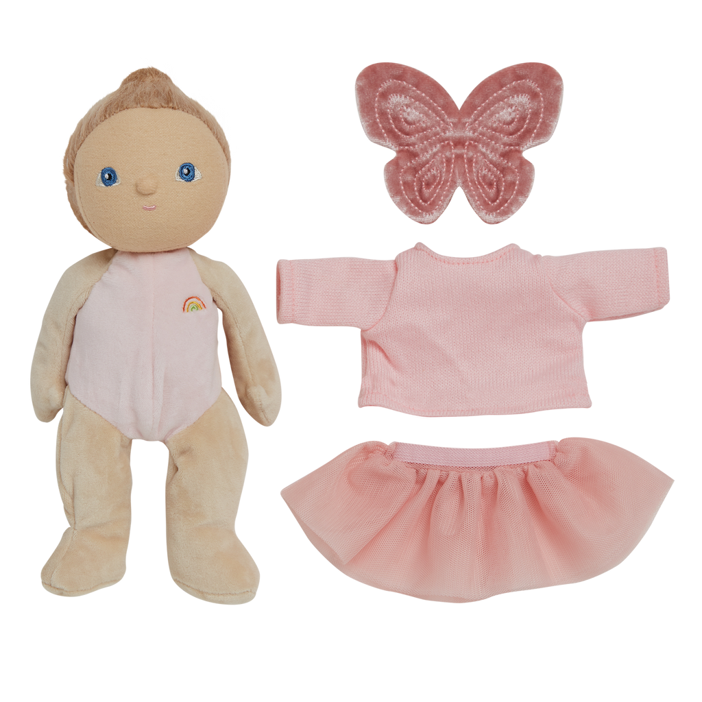 Plush doll with brown hair and blue eyes, wearing a light pink outfit with a rainbow. Includes a pink butterfly, top, and skirt. Set on a white background.