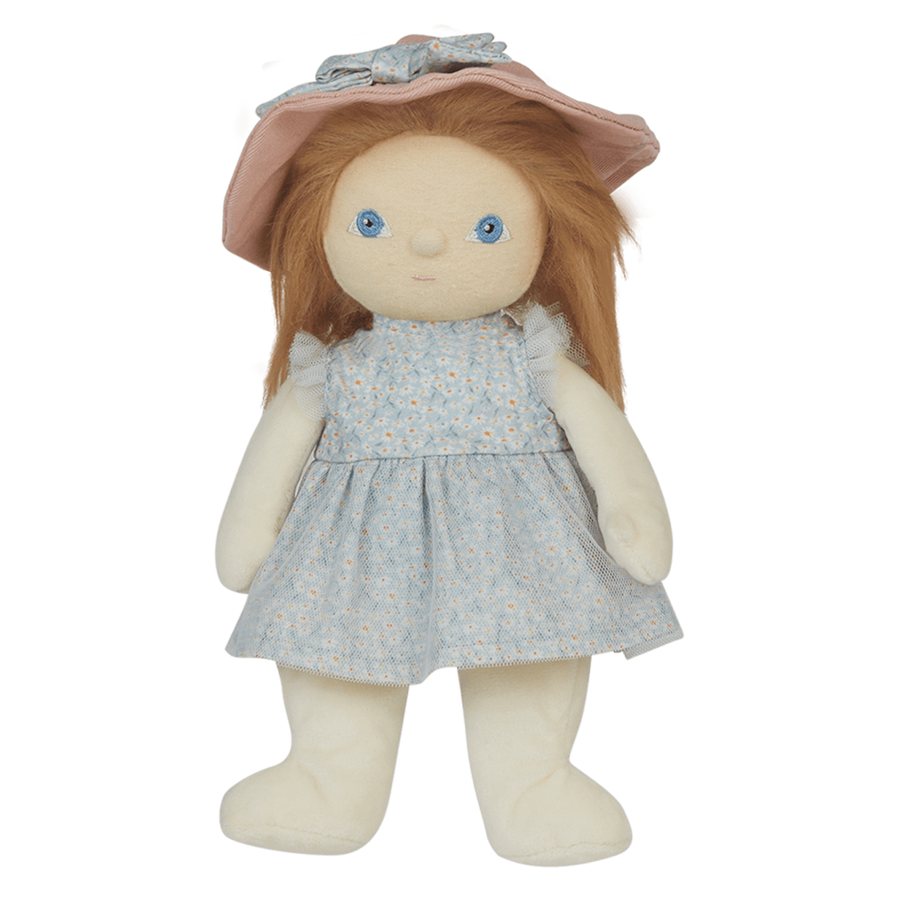 A soft doll with long brown hair wearing a pastel blue dress and a wide-brimmed pink hat. The doll has simple, embroidered blue eyes.