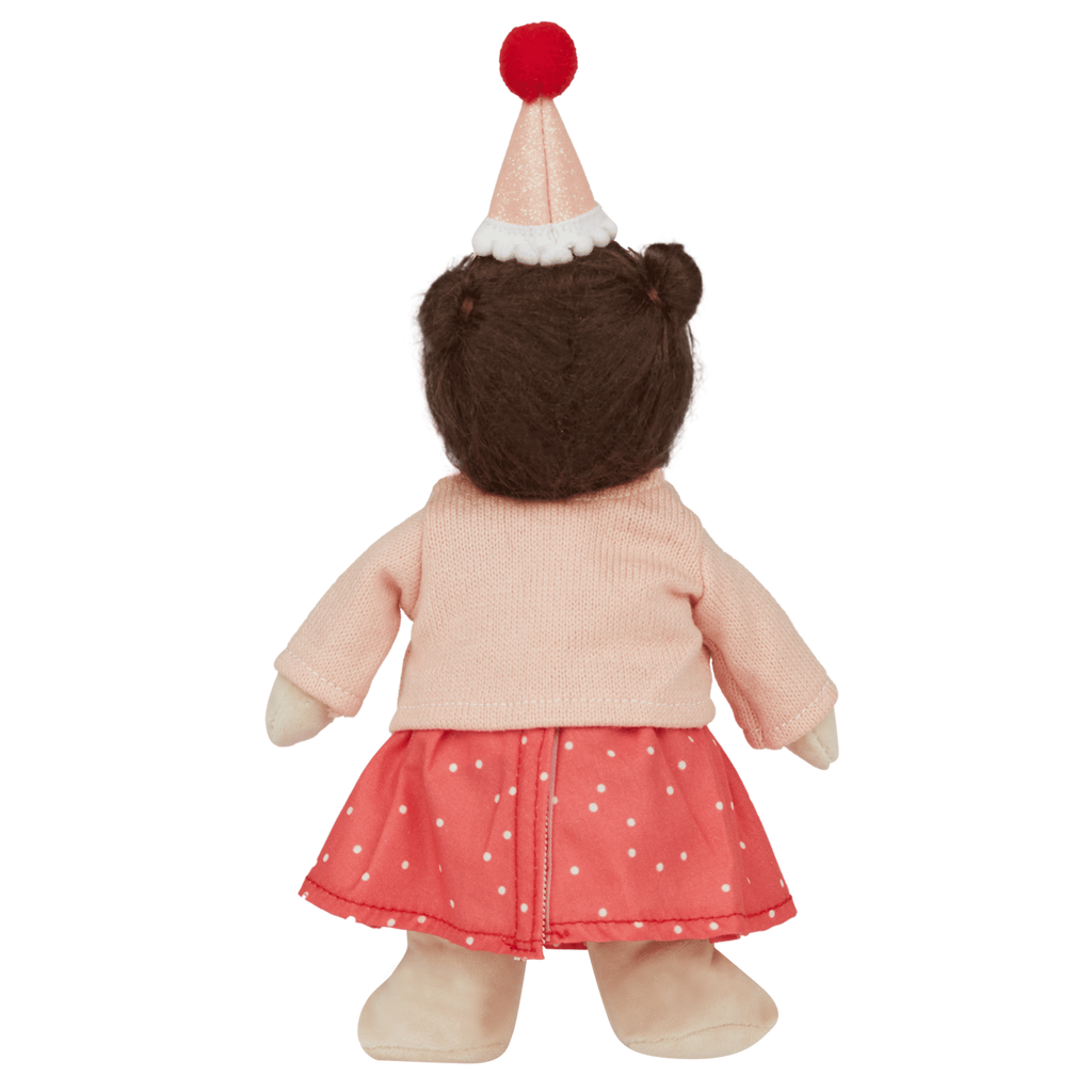 Plush bear wearing a pink sweater, red polka-dot skirt, and a party hat with a red pom-pom, shown from the back against a white background.