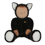 Plush doll dressed as a cat with black fur, white paws and ears, and a tiny rainbow on its chest. The doll's eyes are closed, creating a peaceful expression.