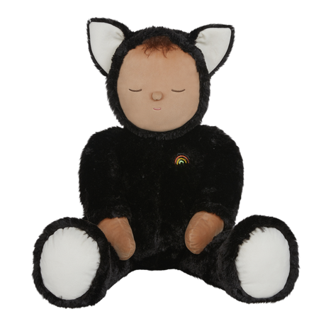 Plush doll dressed as a cat with black fur, white paws and ears, and a tiny rainbow on its chest. The doll's eyes are closed, creating a peaceful expression.