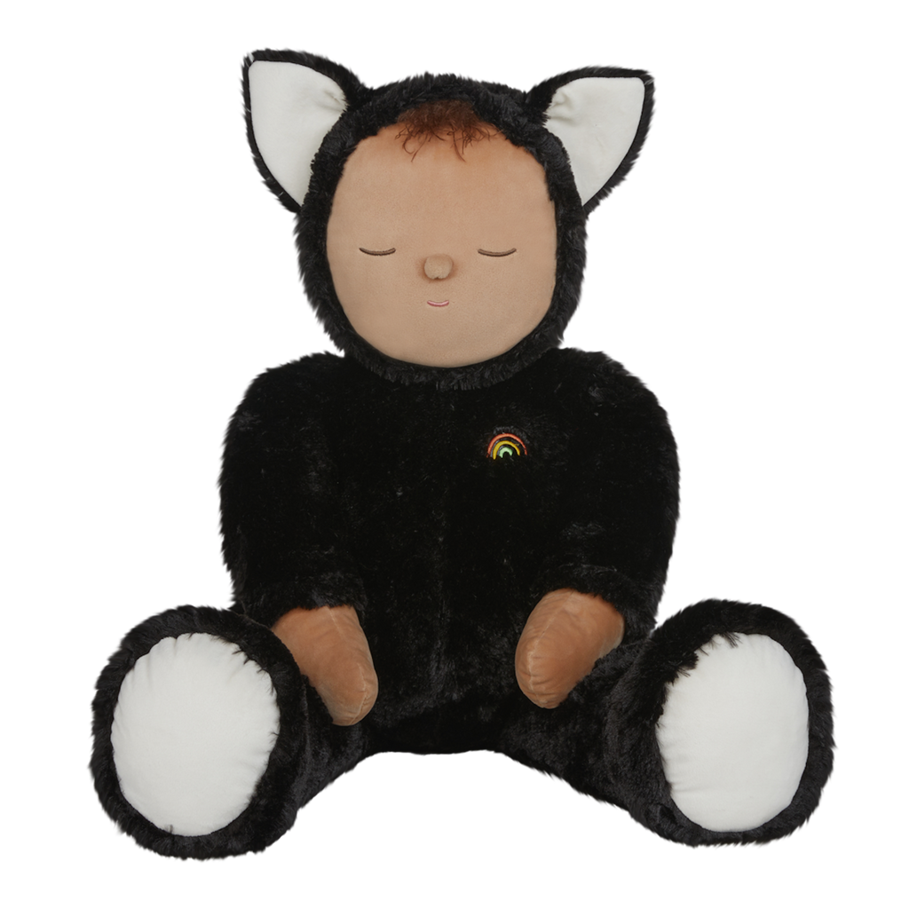Plush doll dressed as a cat with black fur, white paws and ears, and a tiny rainbow on its chest. The doll's eyes are closed, creating a peaceful expression.