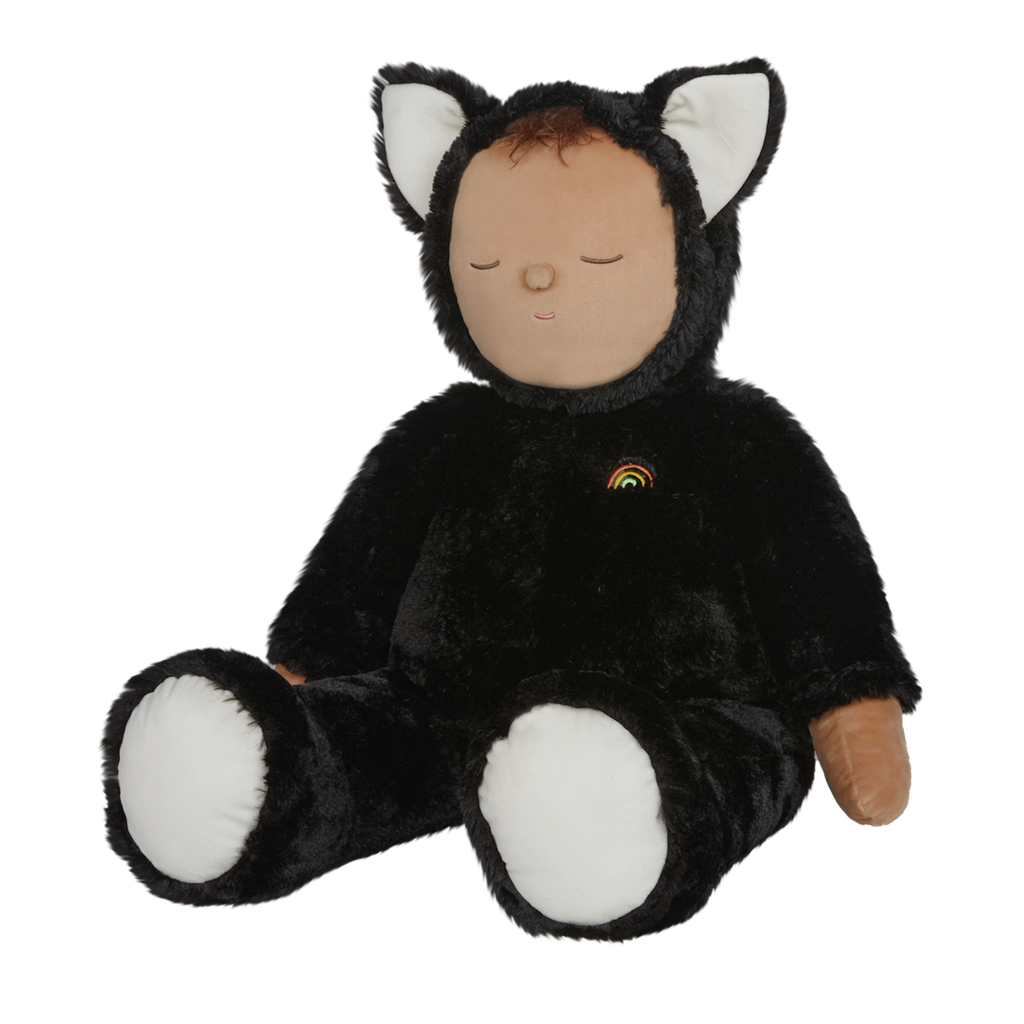 Plush doll dressed as a cat with black fur, white paws and ears, and a tiny rainbow on its chest. The doll's eyes are closed, creating a peaceful expression.
