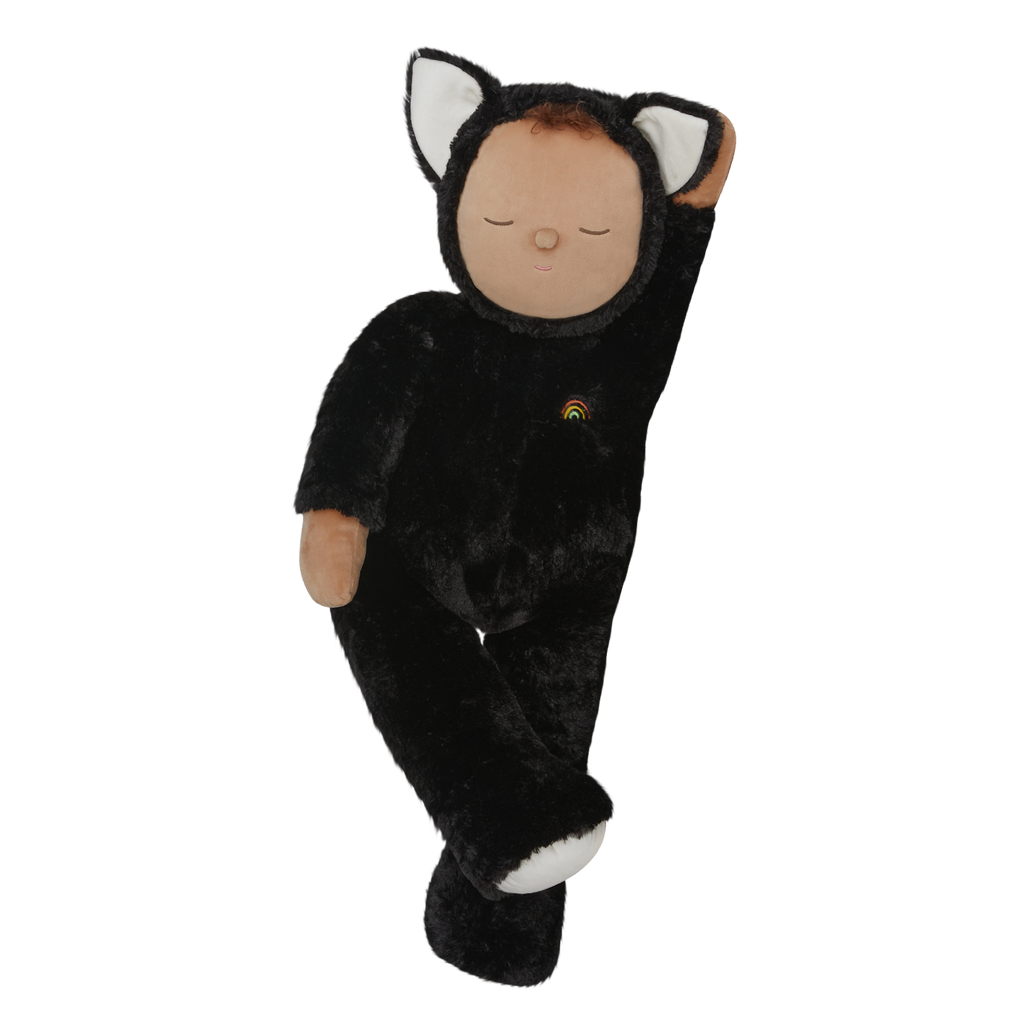 Plush doll dressed as a cat with black fur, white paws and ears, and a tiny rainbow on its chest. The doll's eyes are closed, creating a peaceful expression.