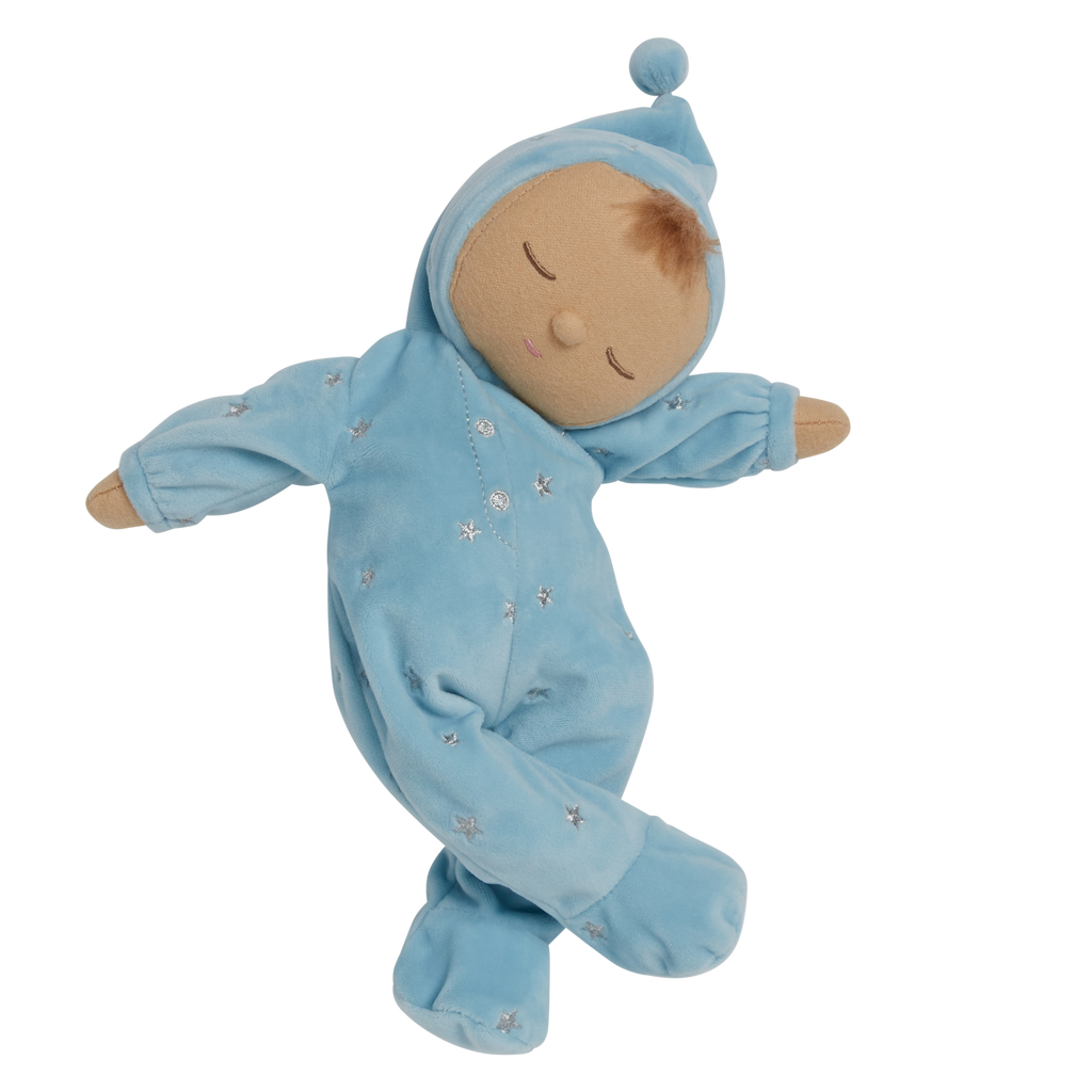 Soft plush doll dressed in a light blue outfit with a pointy hat, embroidered stars, and closed eyes, conveying a peaceful, sleepy tone.
