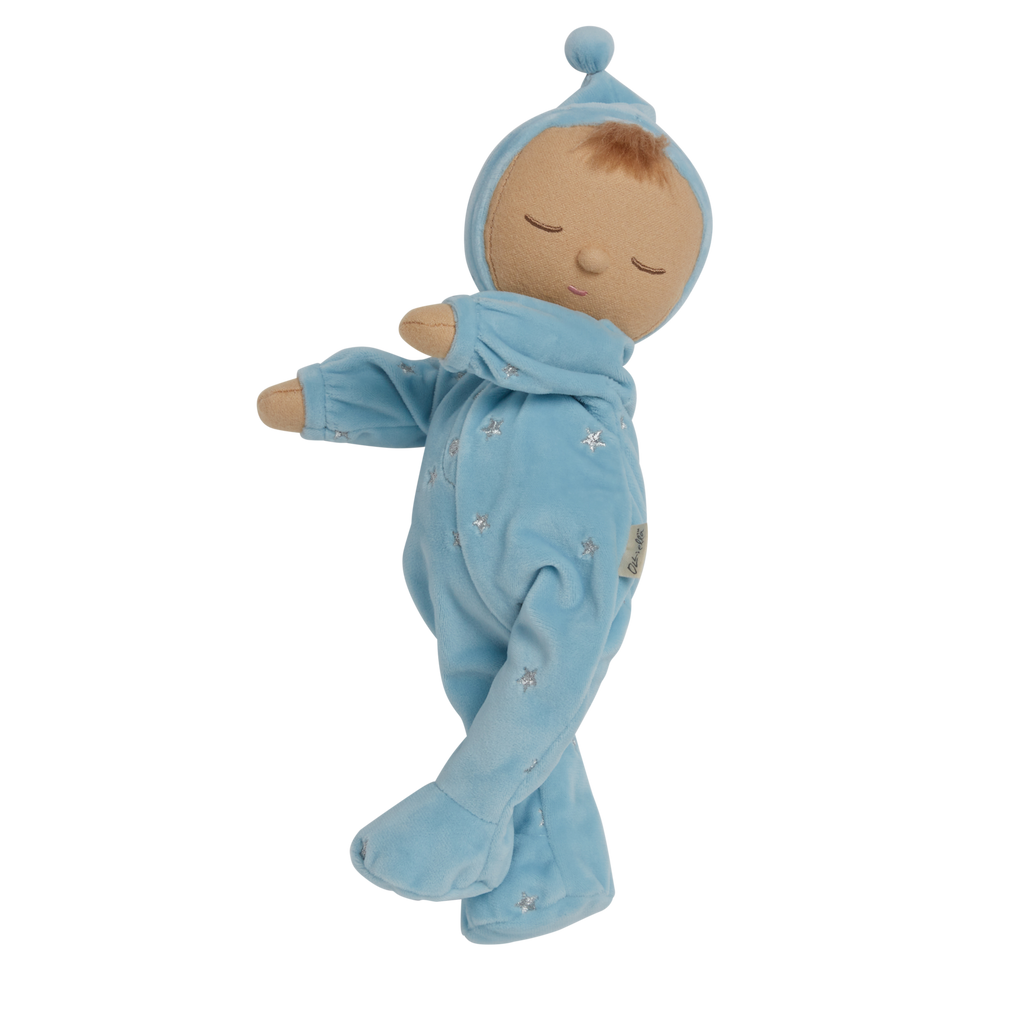 Soft plush doll dressed in a light blue outfit with a pointy hat, embroidered stars, and closed eyes, conveying a peaceful, sleepy tone.