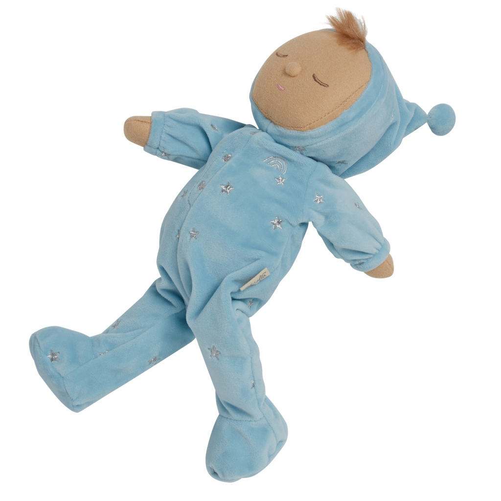 Soft plush doll dressed in a light blue outfit with a pointy hat, embroidered stars, and closed eyes, conveying a peaceful, sleepy tone.