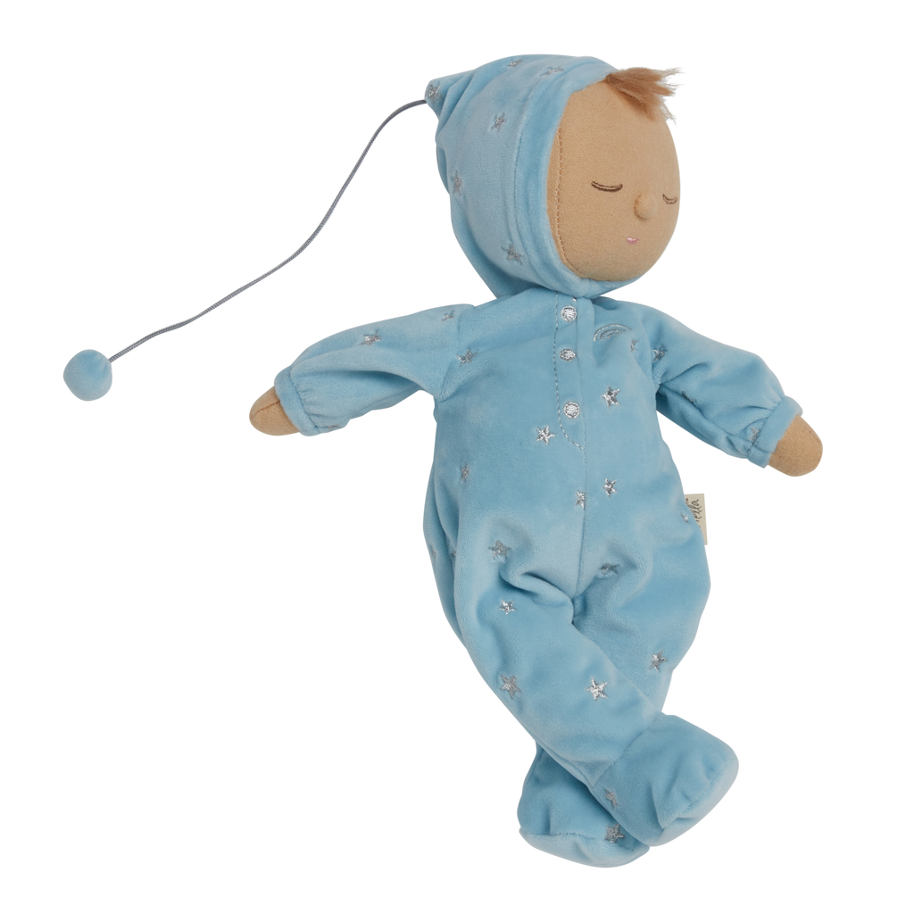 Soft plush doll dressed in a light blue outfit with a pointy hat, embroidered stars, and closed eyes, conveying a peaceful, sleepy tone.