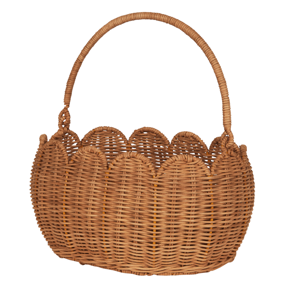 A woven wicker basket with a rounded handle and scalloped edge, set against a white background. The natural texture conveys a rustic, handmade feel.