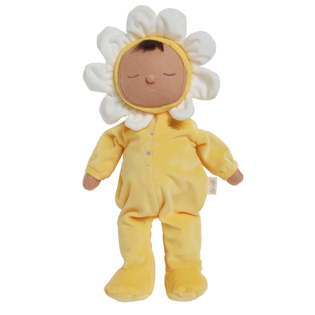 A plush doll with a light brown face framed by white petals, resembling a flower. It wears a soft, yellow bodysuit, conveying a calm, playful vibe.