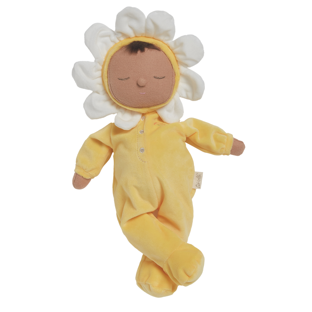 A plush doll with a light brown face framed by white petals, resembling a flower. It wears a soft, yellow bodysuit, conveying a calm, playful vibe.