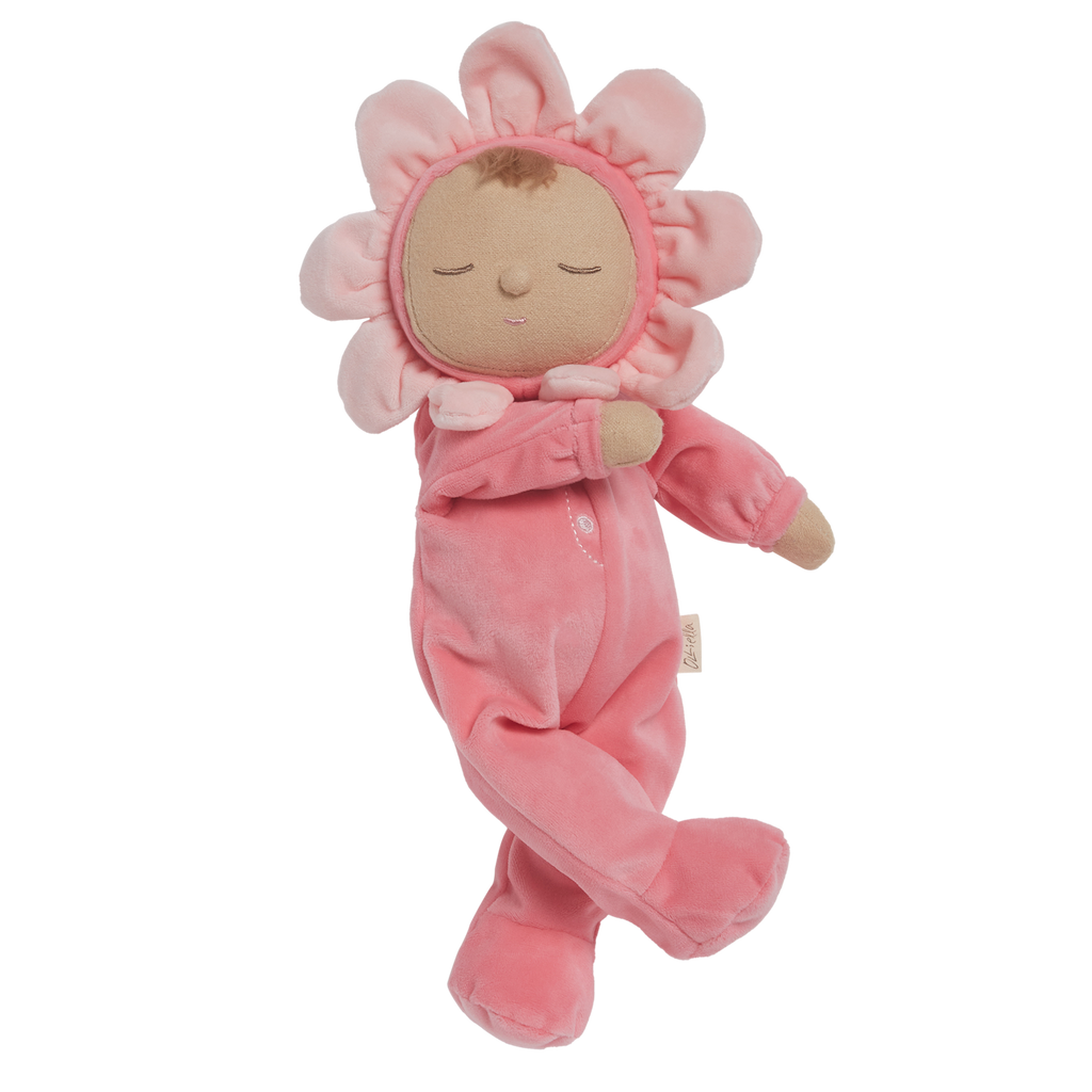 A soft plush toy in a pink floral outfit with closed eyes. The head is encircled by pink petals, evoking a flower. The toy conveys calmness.