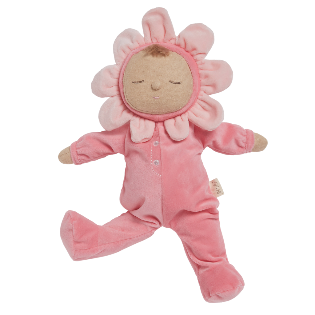 A soft plush toy in a pink floral outfit with closed eyes. The head is encircled by pink petals, evoking a flower. The toy conveys calmness.