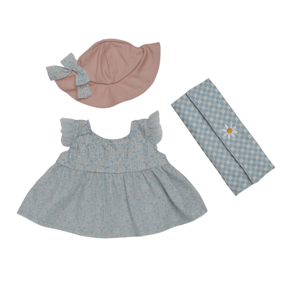 Doll outfit set on white background: a light blue dress with ruffled sleeves, pink hat with bow, and blue checkered blanket with daisy. Delightful and soft.
