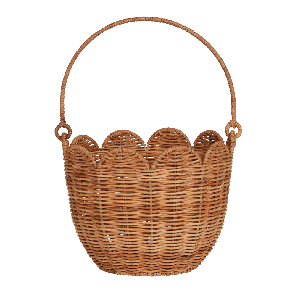 Woven wicker basket with a scalloped edge and a sturdy handle against a white background. The basket has a natural, handmade aesthetic.