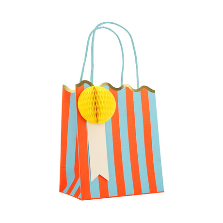 Meri Meri striped party bag with blue and orange stripes, a scalloped gold edge, and a yellow honeycomb paper tag.