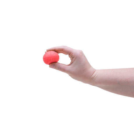A hand holding a small orange basketball from the Teenie NeeDoh Hot Shots multi-pack fidget toy set.