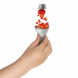 Child's hand squeezing a Squish N' Flow Lava toy lamp with red and orange flowing globs on a white background.