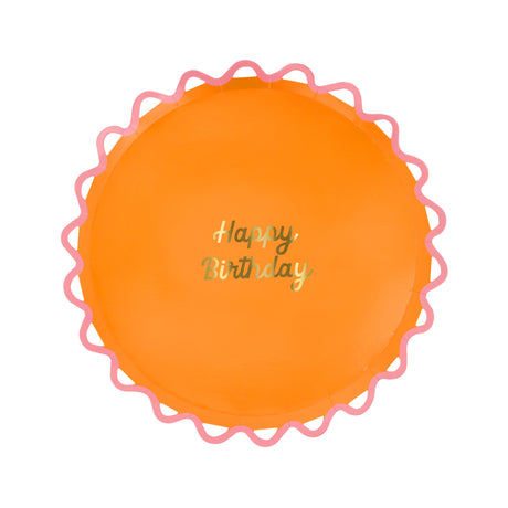 Meri Meri orange Happy Birthday paper plate with a pink wiggle scalloped edge and gold foil script.