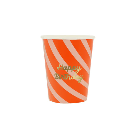 Orange and pink diagonal striped paper cup with "Happy Birthday" written in gold cursive text.