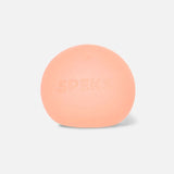 Smooth peach-orange Speks stress ball with embossed lettering on a white background.