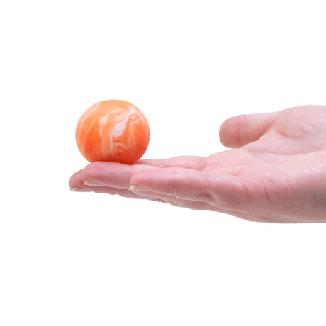 Hand holding an orange and white Swirl Teenie NeeDoh stress ball to show small size. Ideal for sensory play.