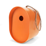 Modern orange oval bamboo fiber birdhouse with a jute hanging rope, perfect for sustainable backyard bird nesting.