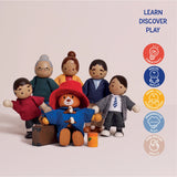 Wooden Paddington Bear and family dolls standing together with educational skill icons on the side.
