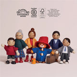 Wooden Paddington Bear and family dolls standing together below sustainable wood and FSC certification logos.