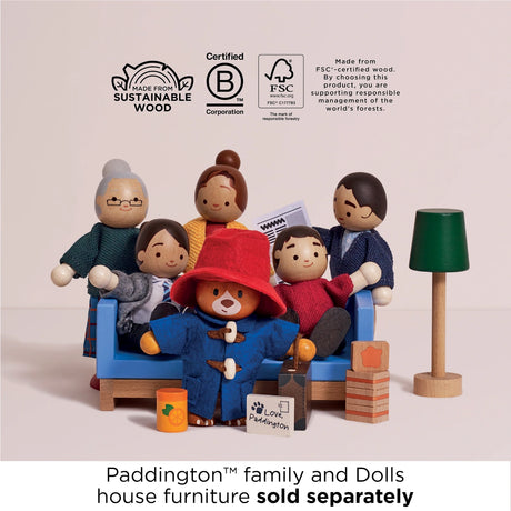 Wooden Paddington Bear and family figure set with blue sofa, lamp, and sustainable wood logos.