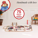 75-piece Paddington wooden train set setup on the floor with tracks, bridge, train, and accessories.