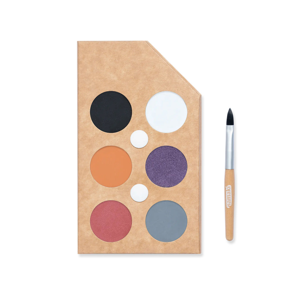 A Namaki face paint palette featuring six colours—black, white, orange, purple, red, and grey—packaged in a sustainable kraft cardboard case with a wooden-handled brush.