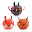Three animal-themed, colorful paper lanterns are shown: a blue owl with vibrant circles around its eyes, a red fox, and an orange squirrel. Whimsical and playful design.