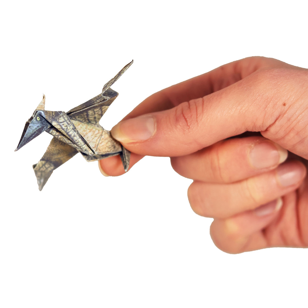 A hand holding a tiny, detailed origami pterodactyl on a white background.