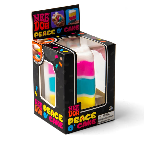 NeeDoh Peace O' Cake toy package showing a colorful cake-shaped squishy toy inside a black box.