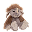 Plush monster toy with grey fur, brown mane, single horn, big floppy ears, and prominent teeth, sitting down.